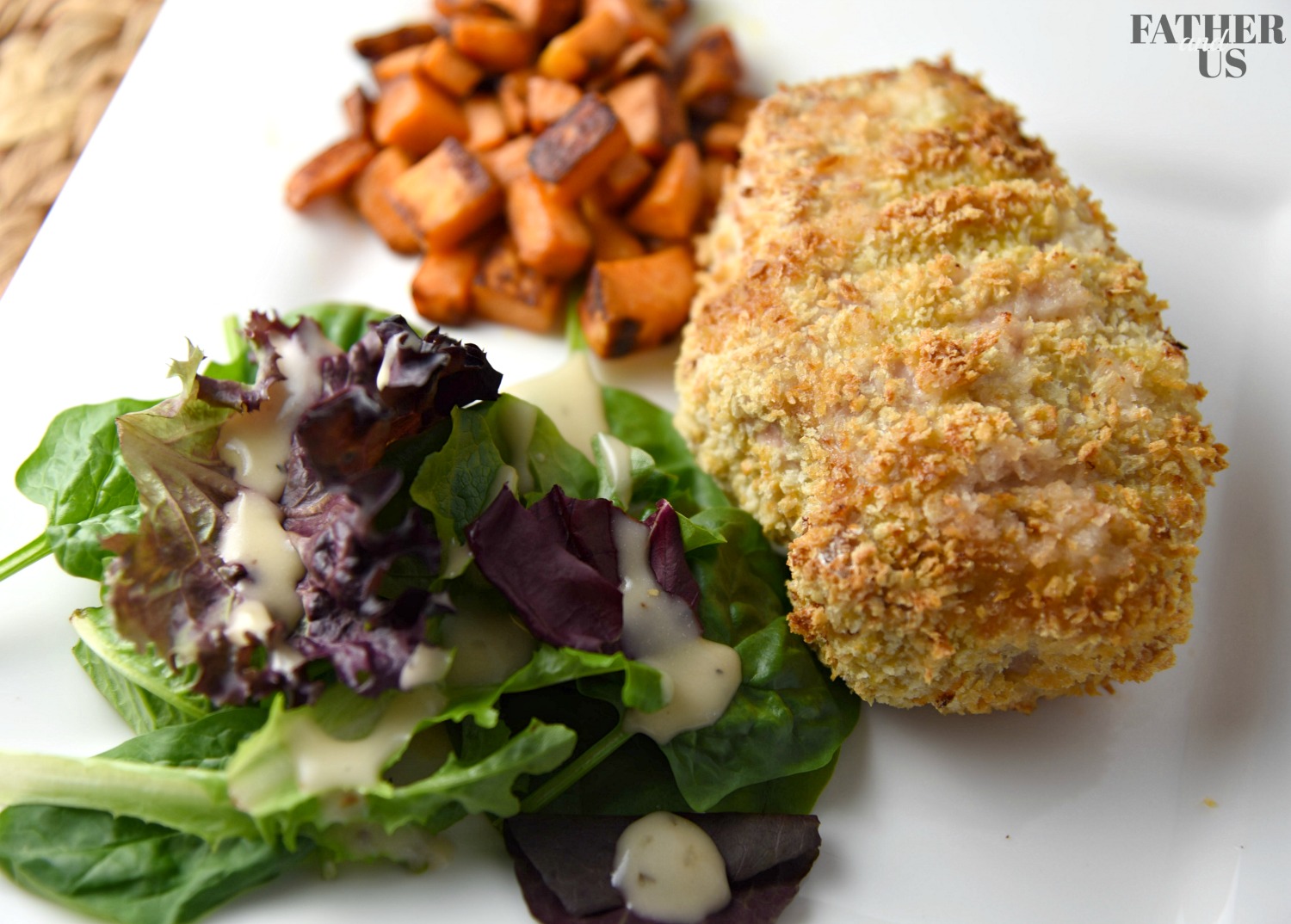 Air Fryer Pork Chops Recipe served on a plate with sweet potato cubes and a light salad