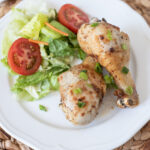 Air Fryer Drumsticks being served with a fresh side salad.