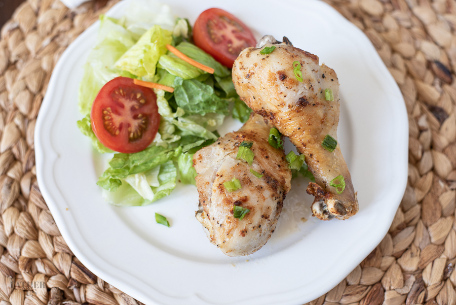 Air Fryer Drumsticks being served with a fresh side salad.